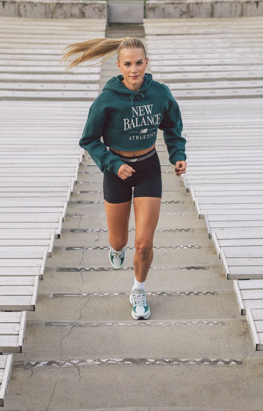 Parker Valby running up bleacher stairs 